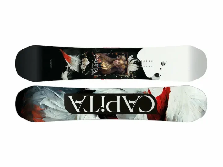 Flat lay of a CAPiTA snowboard featuring a baroque-style female portrait, gold accents and feather motifs on white background, at BSR Ski Shop Bansko.