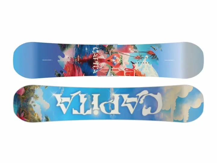 Flat lay of a CAPiTA snowboard featuring vibrant tropical flamingo, floral and cloud graphics on white background, available at BSR Ski Shop in Bansko.